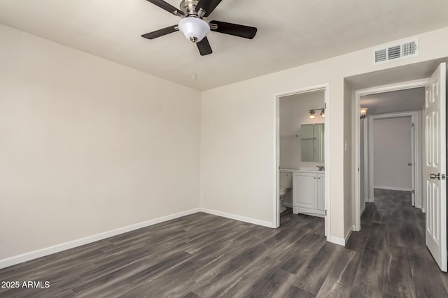 3114 W Villa Maria Dr, Phoenix, AZ 85053 - unfurnished bedroom featuring dark wood-type flooring, a ceiling fan, and ensuite bath