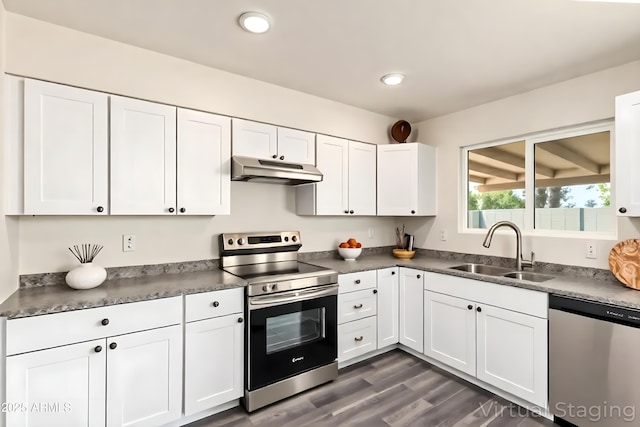 3114 W Villa Maria Dr, Phoenix, AZ 85053 - kitchen featuring appliances with stainless steel finishes, under cabinet range hood, white cabinetry, dark wood-type flooring, and recessed lighting
