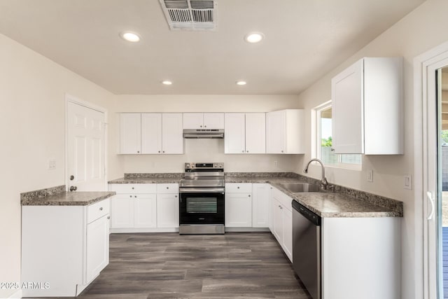 3114 W Villa Maria Dr, Phoenix, AZ 85053 - kitchen with appliances with stainless steel finishes, white cabinets, under cabinet range hood, recessed lighting, and dark wood-type flooring