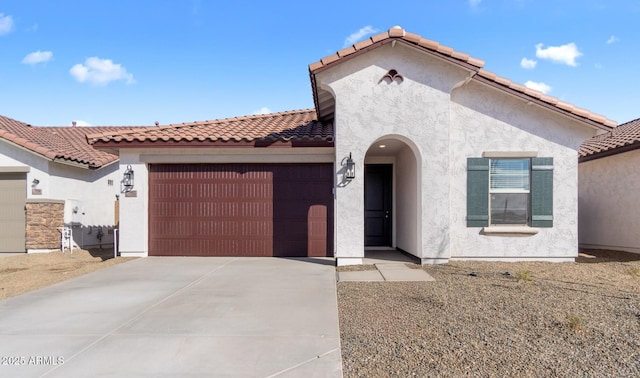 7552 W Park St, Laveen, AZ 85339 - mediterranean / spanish-style home featuring concrete driveway, stucco siding, an attached garage, and a tile roof