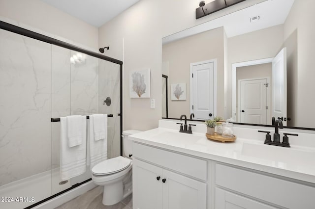 bathroom featuring an enclosed shower, vanity, and toilet