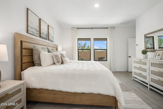 bedroom with dark hardwood / wood-style flooring