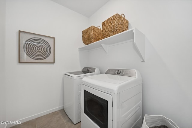 washroom with light tile patterned flooring and independent washer and dryer