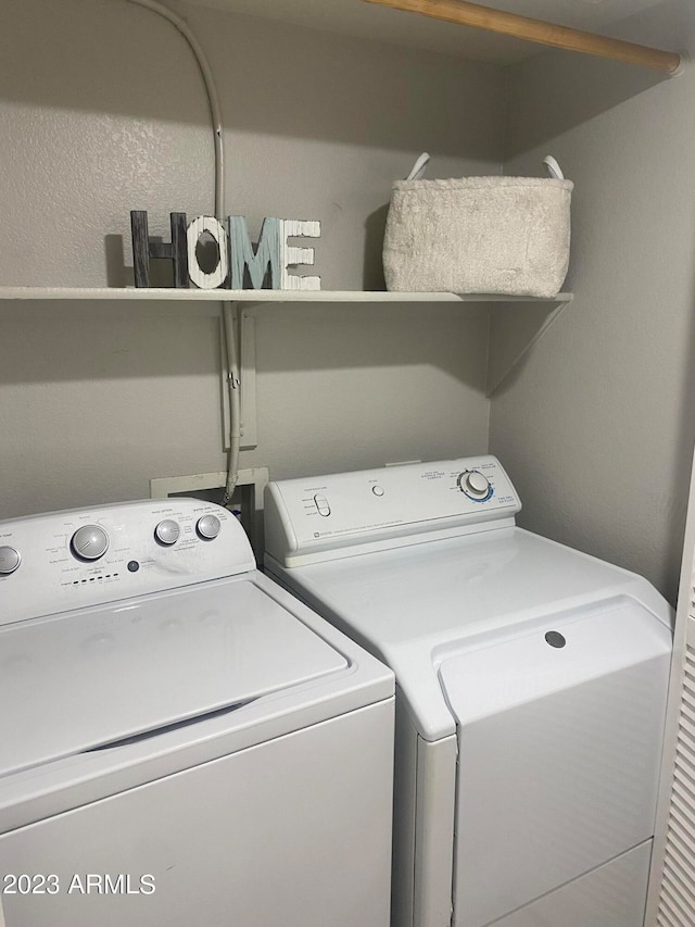 washroom featuring washer and clothes dryer