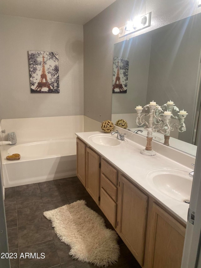 bathroom featuring vanity, tile patterned flooring, and a washtub