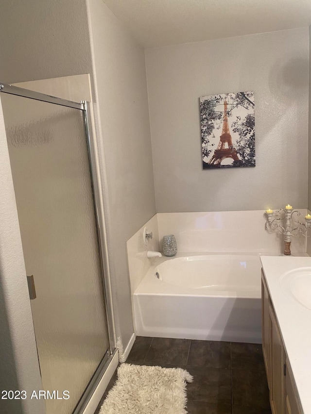 bathroom featuring independent shower and bath, vanity, and tile patterned flooring