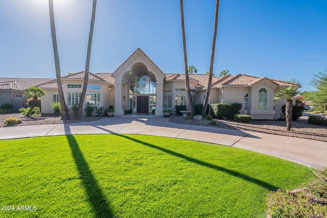 mediterranean / spanish-style home featuring a front lawn