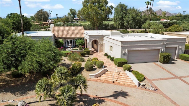 mediterranean / spanish-style home with a garage