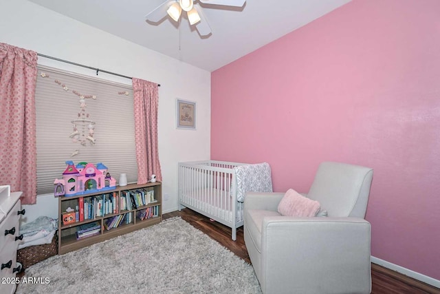 18807 N 42nd Ave, Glendale, AZ 85308 - bedroom with baseboards, a ceiling fan, wood finished floors, and a nursery area