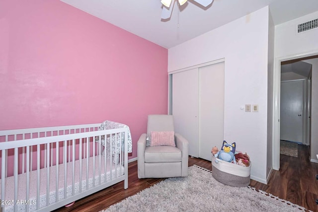 18807 N 42nd Ave, Glendale, AZ 85308 - bedroom featuring a ceiling fan, visible vents, wood finished floors, a crib, and a closet