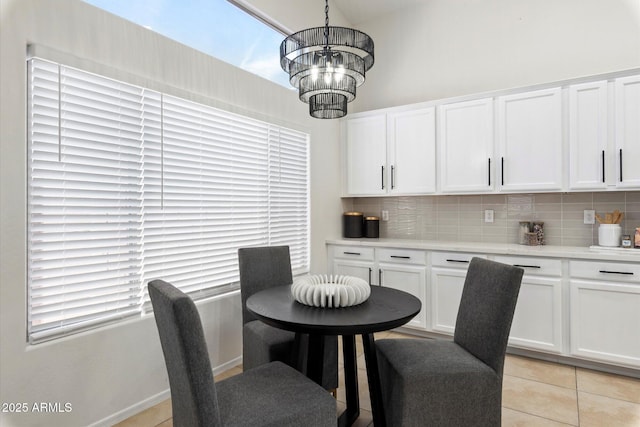 dining room with an inviting chandelier and light tile patterned flooring