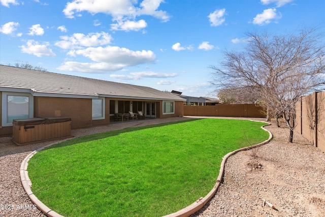 view of yard with a patio area and a hot tub