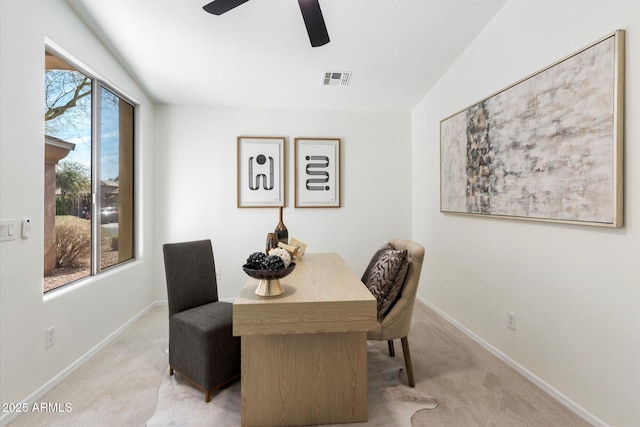 carpeted dining area featuring a healthy amount of sunlight and ceiling fan