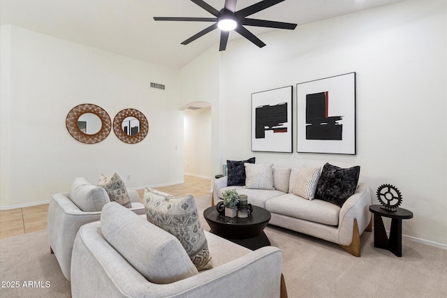 tiled living room featuring high vaulted ceiling and ceiling fan