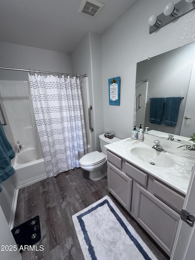 full bathroom with vanity, hardwood / wood-style flooring, toilet, and shower / bath combo with shower curtain