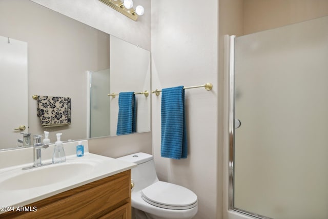 bathroom featuring vanity, toilet, and an enclosed shower