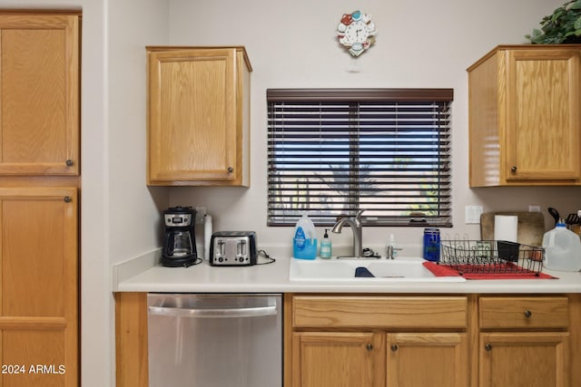 kitchen featuring stainless steel dishwasher, light brown cabinets, and sink