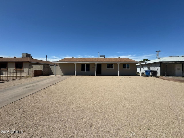 ranch-style house featuring fence