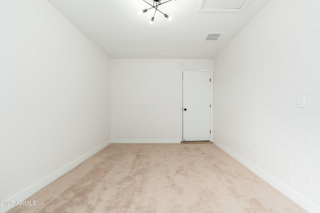 empty room featuring visible vents, baseboards, and light carpet