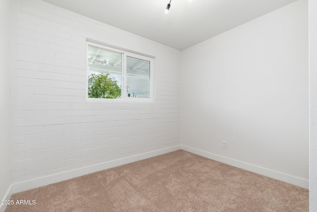 carpeted spare room with baseboards