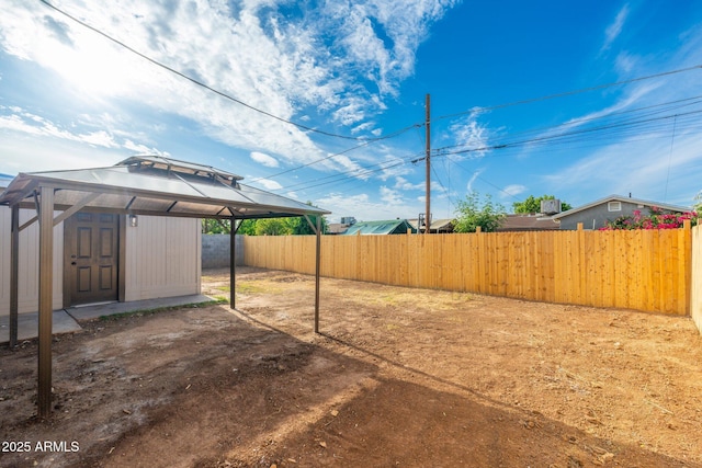 view of yard featuring a gazebo and a fenced backyard
