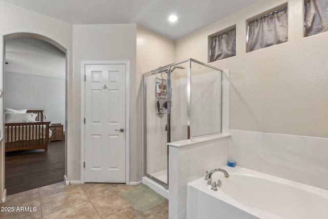 bathroom with baseboards, recessed lighting, a stall shower, tile patterned flooring, and a garden tub