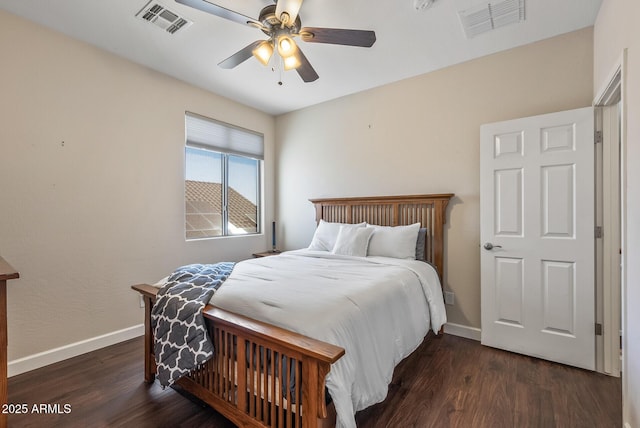 bedroom with visible vents, baseboards, wood finished floors, and a ceiling fan