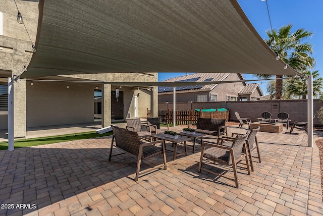 view of patio / terrace featuring an outdoor living space with a fire pit and a fenced backyard