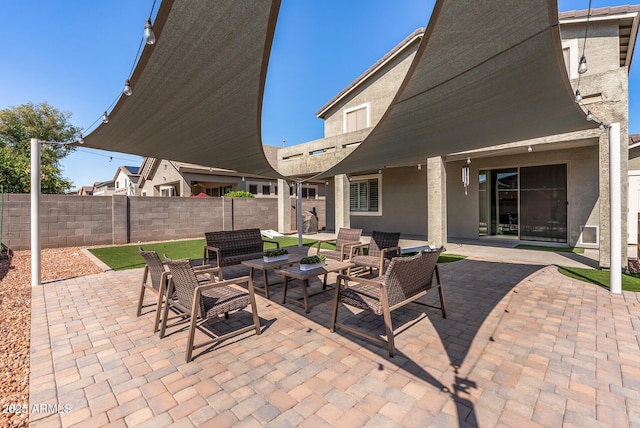 view of patio featuring an outdoor hangout area and fence