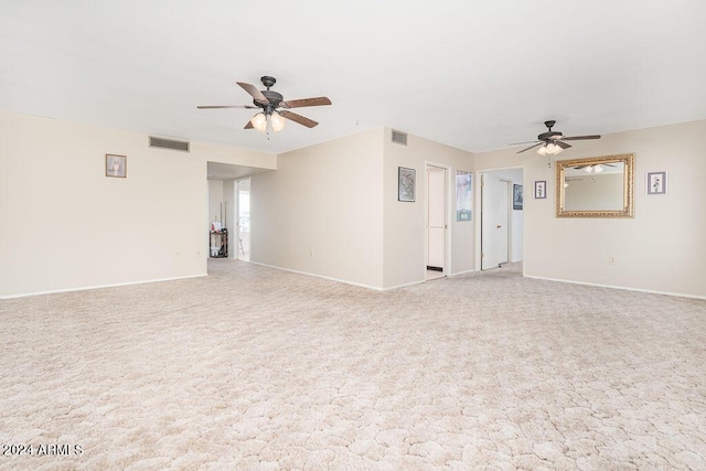 spare room with light colored carpet and ceiling fan