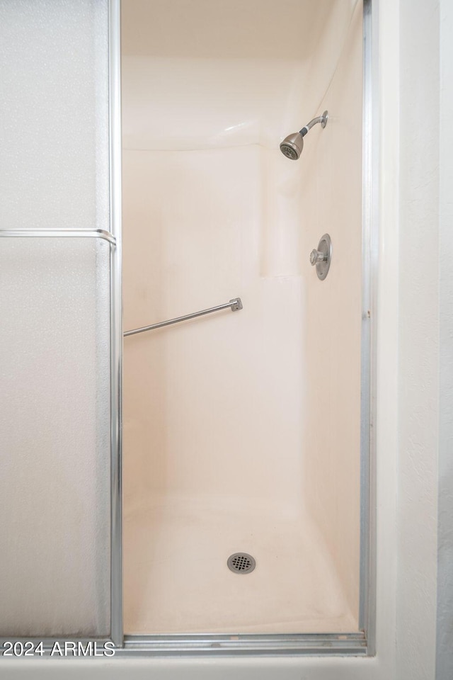 bathroom featuring a shower with shower door