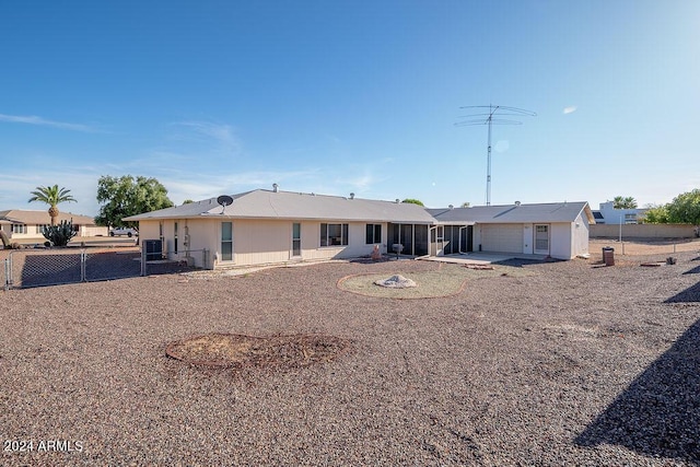 rear view of house with central AC unit and a patio area