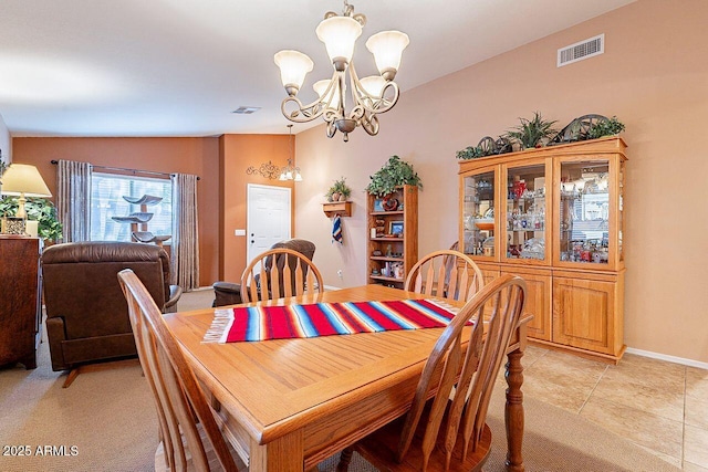 dining area featuring light tile patterned flooring, visible vents, baseboards, and an inviting chandelier