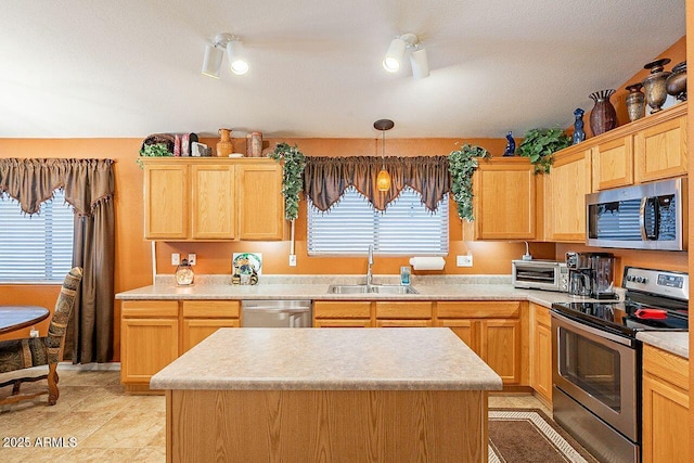 kitchen with a sink, stainless steel appliances, a wealth of natural light, and light countertops