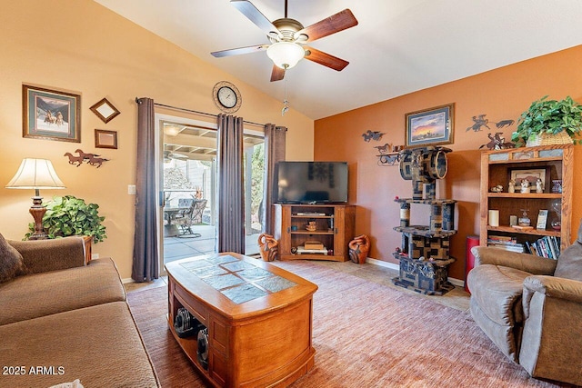 living room with baseboards, a ceiling fan, and vaulted ceiling