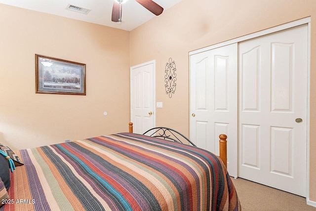 bedroom featuring light colored carpet, visible vents, a closet, and ceiling fan