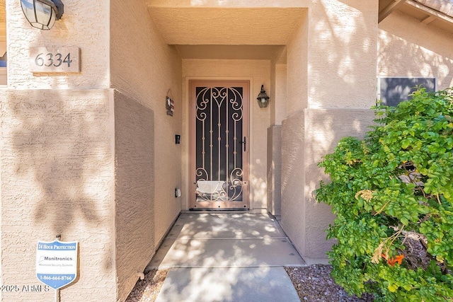 property entrance with stucco siding