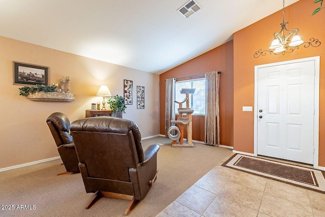 carpeted entrance foyer featuring visible vents, baseboards, lofted ceiling, and an inviting chandelier