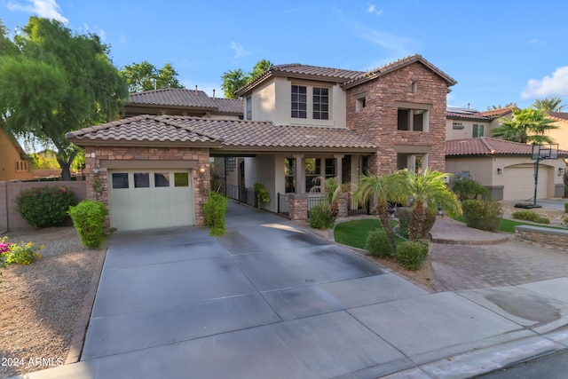 mediterranean / spanish house with a porch and a garage