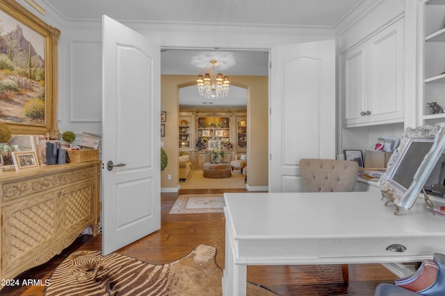 home office featuring crown molding, hardwood / wood-style floors, and an inviting chandelier