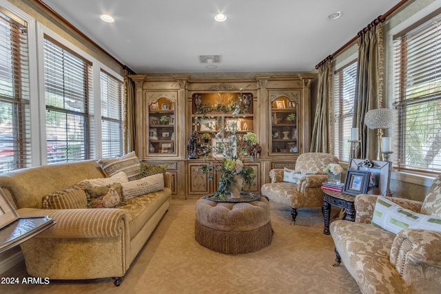 living area featuring a healthy amount of sunlight and light colored carpet