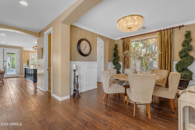 dining area featuring ornamental molding, plenty of natural light, a chandelier, and dark hardwood / wood-style floors