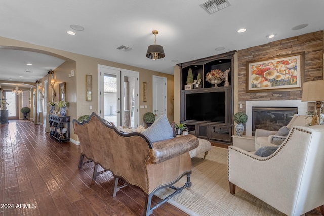 living room with hardwood / wood-style flooring, a fireplace, plenty of natural light, and french doors