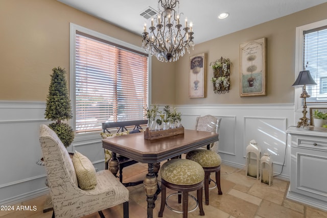 dining space with a healthy amount of sunlight and a chandelier