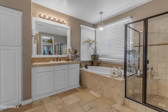 bathroom with vanity and independent shower and bath