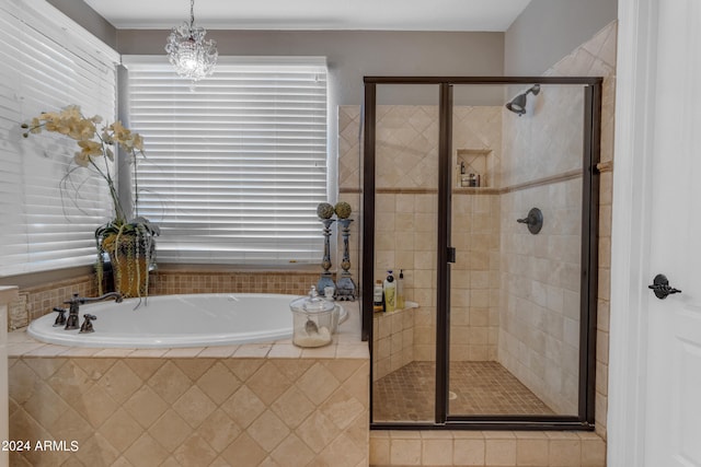 bathroom featuring a notable chandelier and independent shower and bath