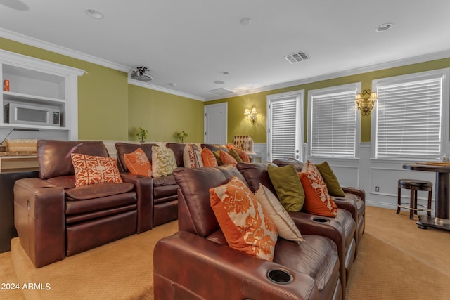 carpeted home theater with crown molding