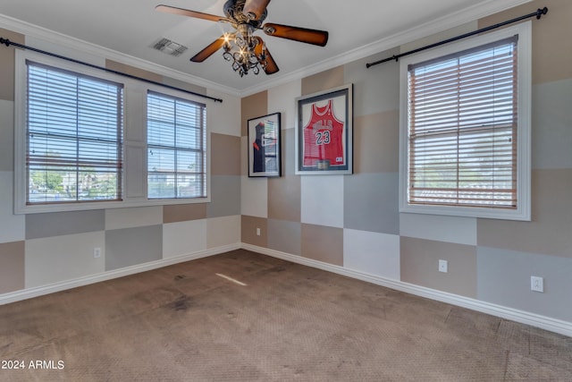 carpeted spare room with crown molding, a wealth of natural light, and ceiling fan