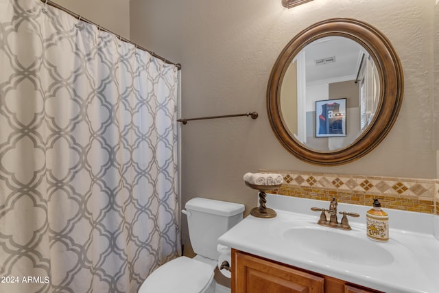 bathroom with ornamental molding, vanity, toilet, and a shower with curtain