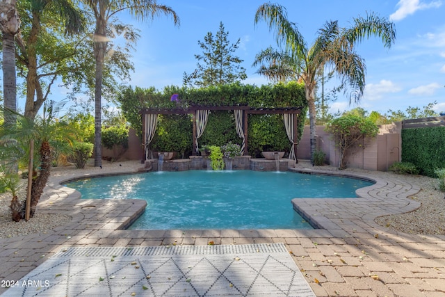 view of swimming pool featuring pool water feature and a patio area